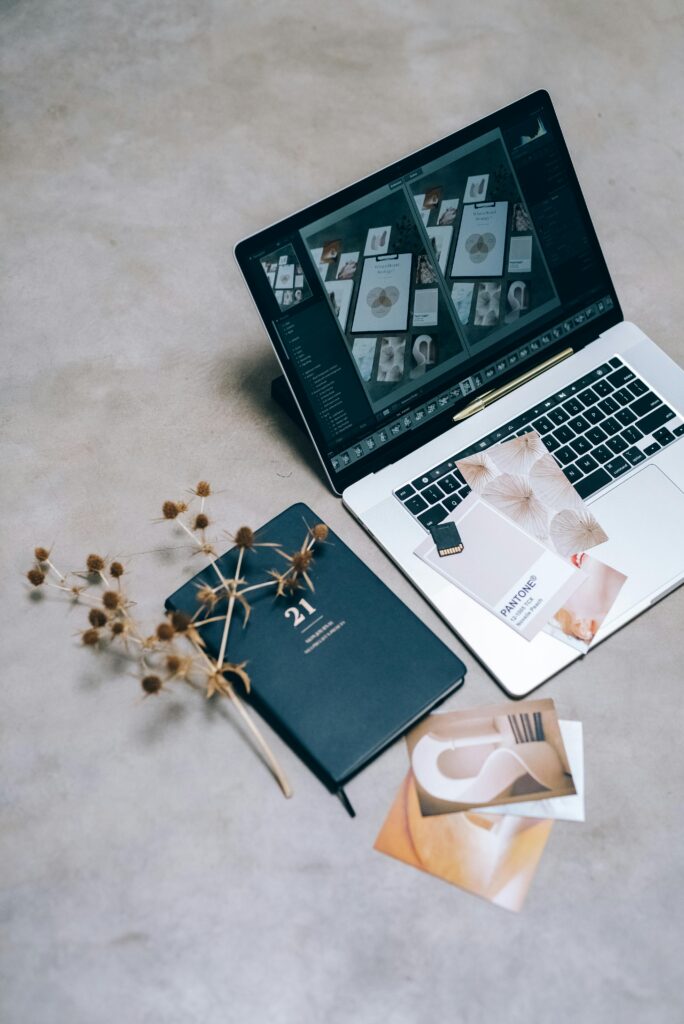 pexels-photo-7610446-7610446 A high-angle shot of a creative workspace featuring a laptop, planner, and dried flowers on a flat surface.
